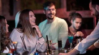 People enjoying their highschool reunion at a bar.
