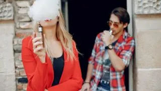 Can Dentists Tell If You Vape -Featured Image of two people standing outside a building vaping.